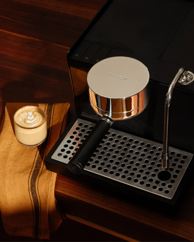 Black - Fellow Espresso Series 1 in Black with hard sun light on it and cappuccino cup that was made by the Fellow Espresso Series espresso machine vellutto.eu